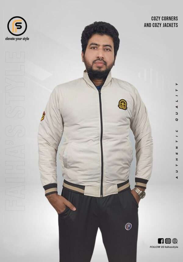 Man modeling a Light Ash beige bomber jacket with a subtle logo on the upper left sleeve. The jacket has ribbed cuffs and hem, adding a snug fit to the classic design. Text overlays read 'Cozy Corners and Cozy Jackets' and 'Authentic Quality,' with 'Faiha's Style' branding in the background