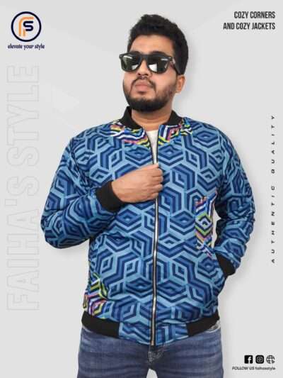 Man wearing a vibrant blue bomber jacket with a geometric pattern. The intricate blue and green cube design gives a modern, textured look. Branding texts 'Cozy Corners and Cozy Jackets' and 'Authentic Quality' are overlaid, with 'Faiha's Style' subtly incorporated in the background.